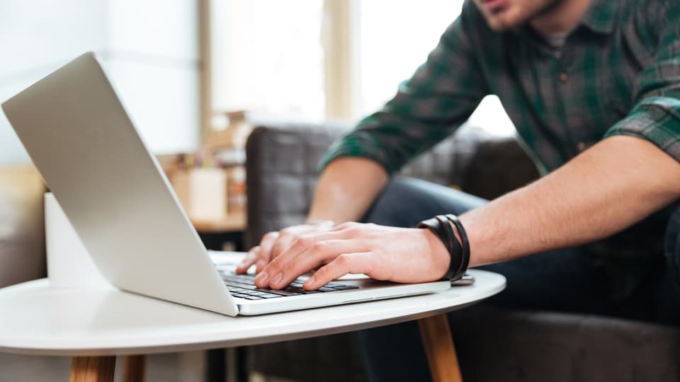 18462973-cropped-image-of-man-with-laptop-by-the-table-16-9-foto Dean Drobot.jpg